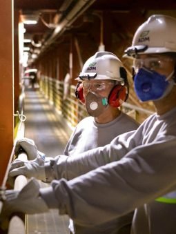two-men-with-hard-hats-and-respirators-standing-inside-loading-facility-in-port-santos_saopaulo-1033